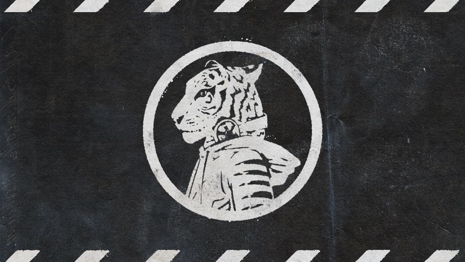 White stencil-style tiger head in profile wearing headphones and a hooded cloak inside a circle, on a distressed black background with film clapboard stripes.