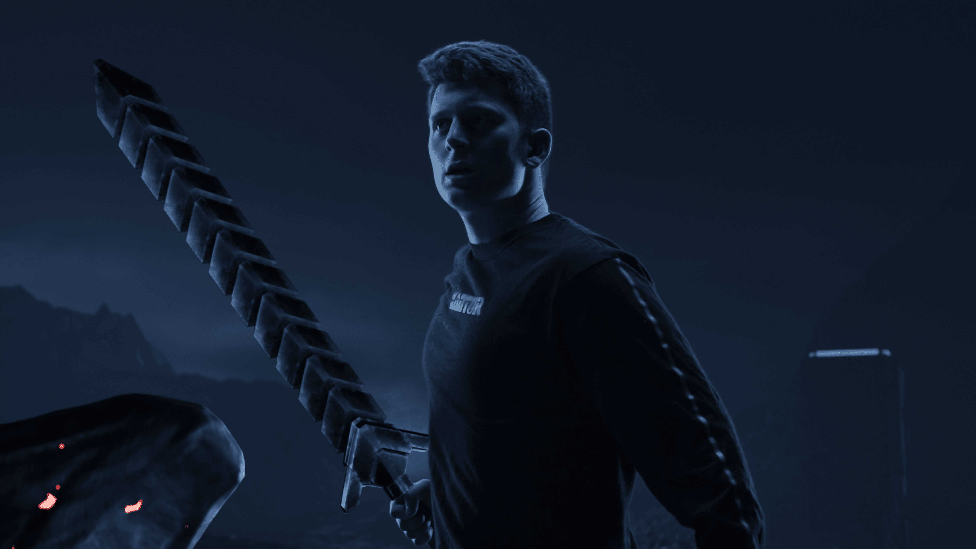 A young man with an alert expression holds a large, blocky sword in a dark, blue-toned environment, with glowing red embers visible in the foreground.