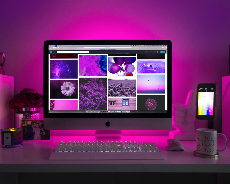 Desktop computer on a pink neon desk