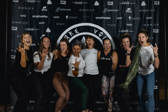 Group standing in front of We Are Viking Yoga step and repeat banner